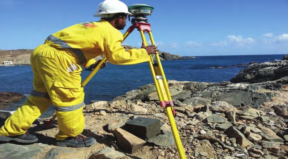 Surveyor observing coastal control with a total station